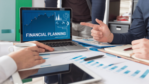Financial planning concept with laptop showing charts and a business meeting — design thinking for CFOs