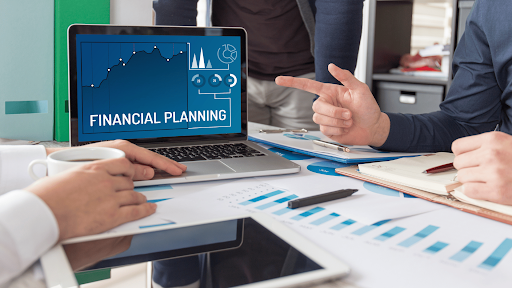 Financial planning concept with laptop showing charts and a business meeting — design thinking for CFOs